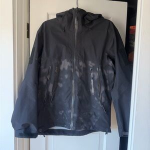 Arc'teryx Men's Black Hooded Shell Jacket with Subtle Washed Camo Pattern